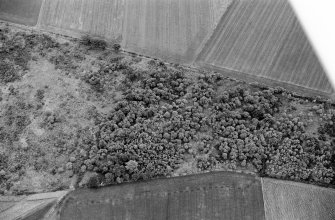 Oblique aerial view centred on the remains of a barrow at Midtown of Pitglassie, looking to the ESE.