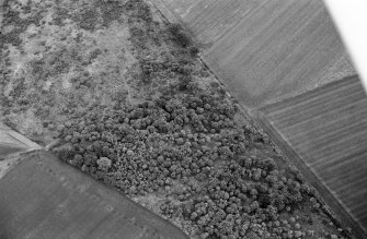 Oblique aerial view centred on the remains of a barrow at Midtown of Pitglassie, looking to the ENE.