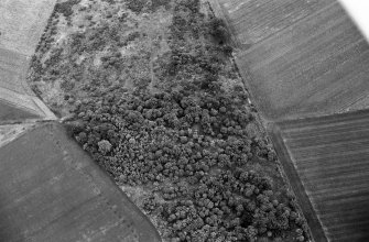 Oblique aerial view centred on the remains of a barrow at Midtown of Pitglassie, looking to the NNE.