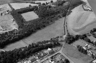 Oblique aerial view centred on the cropmarks of ring ditches, pits and possible souterrains at Nairn, looking to the WSW.