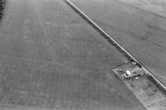 Oblique aerial view centred on the cropmarks of an enclosure at Garble Croft, looking to the SSE.