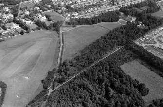 Oblique aerial view centred on the cropmarks of the unenclosed settlement, ring ditches, pits and possible souterrains at Nairn, looking to the ENE.