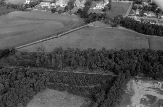 Oblique aerial view centred on the cropmarks of the unenclosed settlement, ring ditches, pits and possible souterrains at Nairn, looking to the NE.