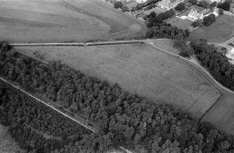 Oblique aerial view centred on the cropmarks of the unenclosed settlement, ring ditches, pits and possible souterrains at Nairn, looking to the N.