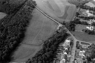 Oblique aerial view centred on the cropmarks of the unenclosed settlement, ring ditches, pits and possible souterrains at Nairn, looking to the WNW.