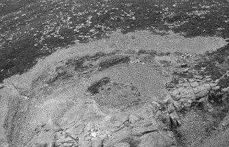 Oblique aerial view centred on the remains of the fort at Mither Tap of Bennachie, looking to the SE.