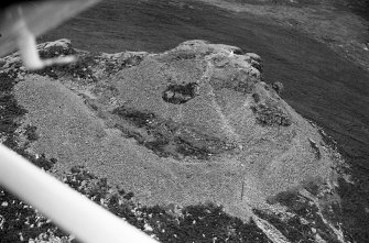 Oblique aerial view centred on the remains of the fort at Mither Tap of Bennachie, looking to the WSW.