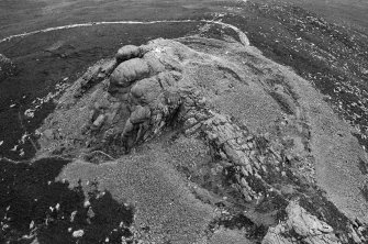 Oblique aerial view centred on the remains of the fort at Mither Tap of Bennachie, looking to the NNE.