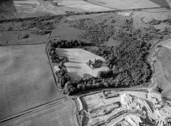 Oblique aerial view centred on the remains of Restenneth Priory with pits and a possible souterrain adjacent, looking to the NE.
