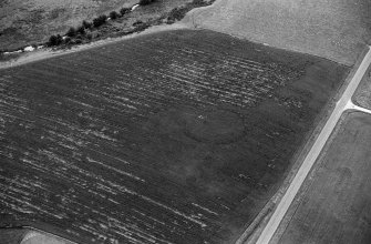 Oblique aerial view centred on the cropmarks of the circular enclosure at Barflat, looking to the SSE.