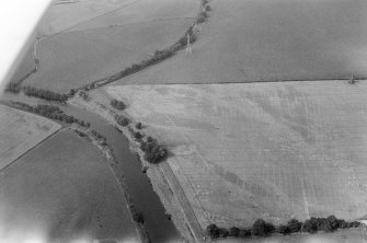 Oblique aerial view centred on the cropmarks of enclosures, linear features, a possible souterrain and rig at Balnakewan, looking to the NW.