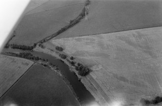 Oblique aerial view centred on the cropmarks of enclosures, linear features, a possible souterrain and rig at Balnakewan, looking to the NNW.