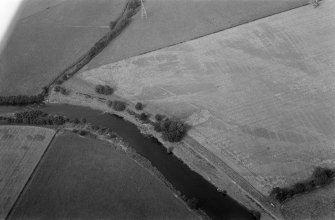 Oblique aerial view centred on the cropmarks of enclosures, linear features, a possible souterrain and rig at Balnakewan, looking to the NNW.