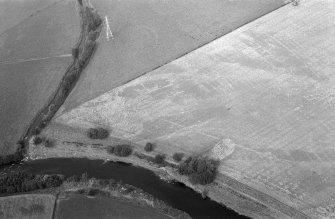 Oblique aerial view centred on the cropmarks of enclosures, linear features, a possible souterrain and rig at Balnakewan, looking to the NNE.