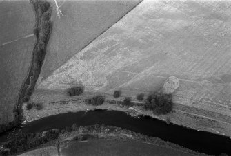 Oblique aerial view centred on the cropmarks of enclosures, linear features, a possible souterrain and rig at Balnakewan, looking to the NE.