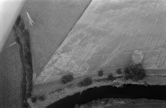 Oblique aerial view centred on the cropmarks of enclosures, linear features, a possible souterrain and rig at Balnakewan, looking to the ENE.