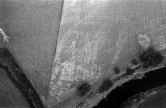 Oblique aerial view centred on the cropmarks of enclosures, linear features, a possible souterrain and rig at Balnakewan, looking to the ENE.