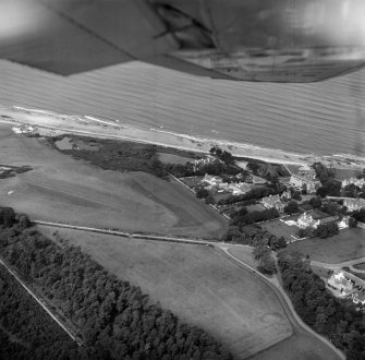 Oblique aerial view centred on the cropmarks of ring ditches, pits and possible souterrains at Nairn, looking to the NNW.