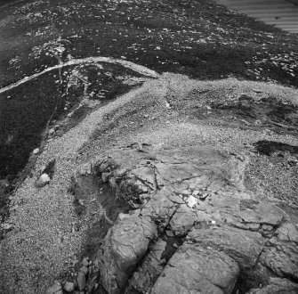 Oblique aerial view centred on the remains of the fort at Mither Tap of Bennachie, looking to the NNE.