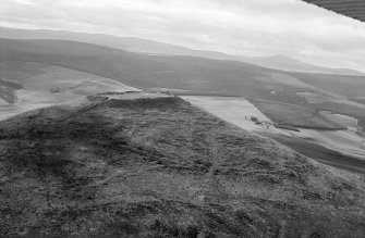 Oblique aerial view centred on the remains of the vitrified fort at Tap O' Noth, looking to the W.