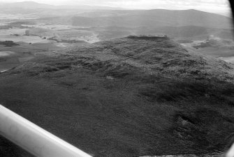 Oblique aerial view centred on the remains of the vitrified fort at Tap O' Noth, looking to the SW.
