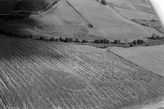 Oblique aerial view centred on the cropmarks of the circular enclosure at Barflat, looking to the SE.