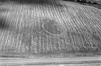 Oblique aerial view centred on the cropmarks of the circular enclosure at Barflat, looking to the ESE.