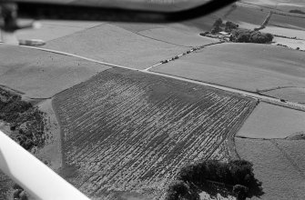 Oblique aerial view centred on the cropmarks of the circular enclosure at Barflat, looking to the WSW.