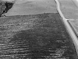 Oblique aerial view centred on the cropmarks of the circular enclosure at Barflat, looking to the SSW.