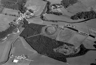Oblique aerial view centred on the remains of the castle and motte of Doune of Invernochty, looking to the ESE.
