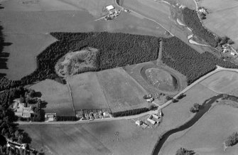 Oblique aerial view centred on the remains of the castle and motte of Doune of Invernochty, looking to the NW.