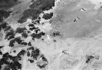 Oblique aerial view centred on the remains of hut circles and the midden at Sands of Forvie.