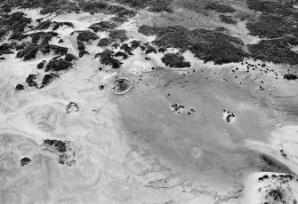 Oblique aerial view centred on the remains of hut circles and the midden at Sands of Forvie.