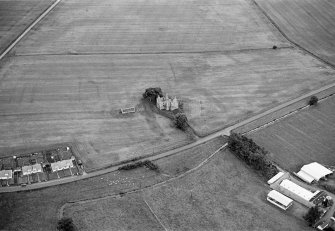 Oblique aerial view of Leslie Castle with cropmarks of linear features, pits and the moat ditch visible, looking to the NNE.