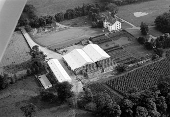Oblique aerial view centred on Gallery House and gardens with cropmarks adjacent, looking to the SSW.