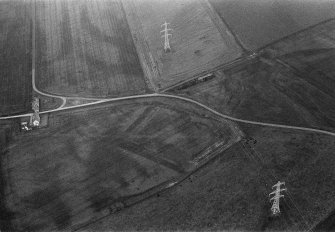 Oblique aerial view centred on the cropmarks of the moated site at Hallyards, looking to the ENE.