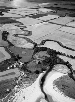 Oblique aerial view centred on the remains of Red Castle, Lunan, looking to the WNW.