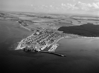 Oblique aerial view centred on the town and harbour of Burghead, looking to the E.