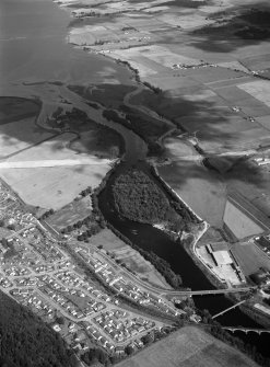 General oblique aerial view centred on Maryburgh, Garrie Island and the Conan Bridge under construction, looking to the NE.