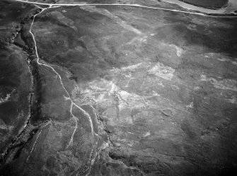 Oblique aerial view centred on the remains of hut circles at Torrish Burn, looking to the SSW.