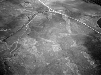 Oblique aerial view centred on the remains of hut circles at Torrish Burn, looking to the SE.