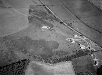 Oblique aerial view centred on the remains of hut circles at Camore and Sydera Wood, looking to the E.