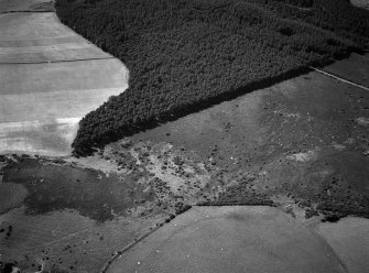 Oblique aerial view centred on the remains of hut circles at Camore and Sydera Wood, looking to the WNW.