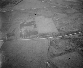 Oblique aerial view centred on the remains of the stone rows at the Hill O' Many Stanes, Clyth with cropmarks adjacent, looking to the NE.
