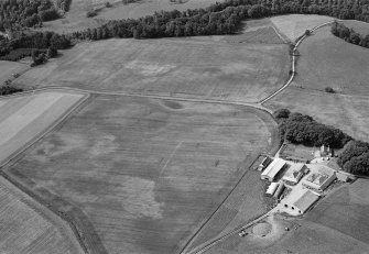 Oblique aerial view centred on the cropmarks of possible enclosures, pits and rig at Kinalty with the farmstead adjacent, looking to the WSW.