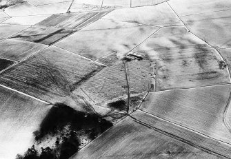 Oblique aerial view centred on the remains of rig and furrow with the farmstead adjacent at Spy Far, looking to the SW.