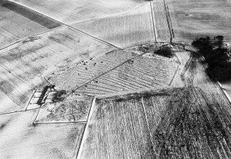 Oblique aerial view centred on the remains of rig and furrow with the farmstead adjacent at Spy Far, looking to the WSW.