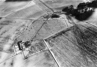 Oblique aerial view centred on the remains of rig and furrow with the farmstead adjacent at Spy Far, looking to the WSW.