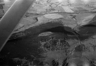 Oblique aerial view centred on the remains of the fort at White Caterthun, looking to the NW.