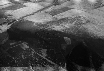Oblique aerial view centred on the remains of the fort at Brown Caterthun, looking to the ENE.